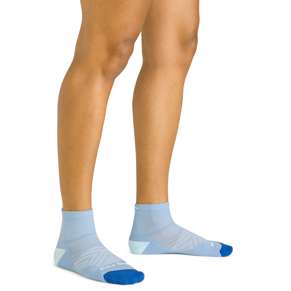 Darn Tough women's Run Quarter sock in Sky worn on feet, showing the quarter-height cuff