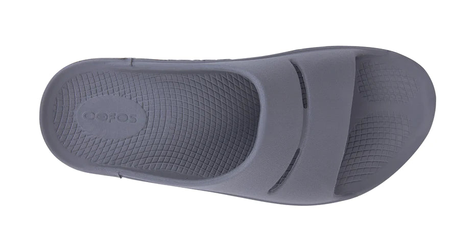 OOahh - Unisex by Oofos in grey slide with agile OOfoam strap absorbing 37% more impact for superior comfort and support