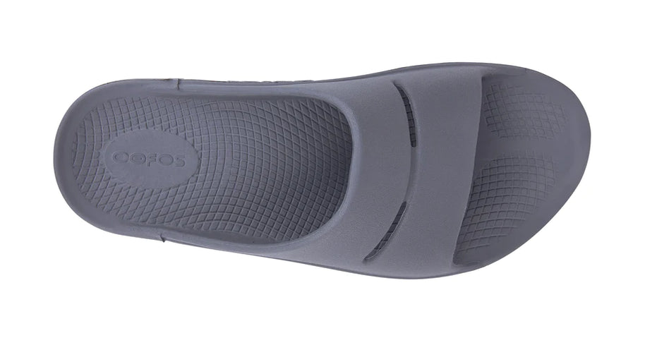 OOahh - Unisex by Oofos in grey slide with agile OOfoam strap absorbing 37% more impact for superior comfort and support