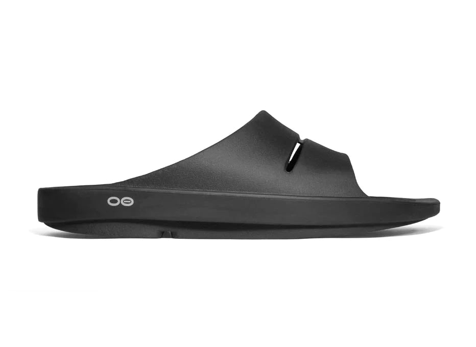 OOahh - Unisex by Oofos in black, lightweight slides with OOfoam strap for impact absorption and superior comfort, ideal for recovery.