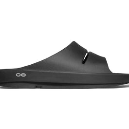 OOahh - Unisex by Oofos in black, lightweight slides with OOfoam strap for impact absorption and superior comfort, ideal for recovery.