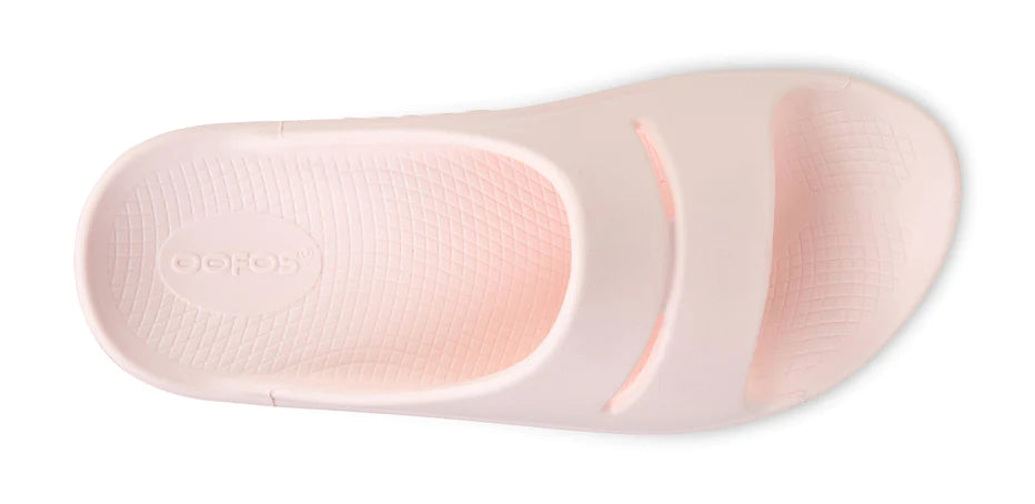 OOahh - Unisex by Oofos in light pink with OOfoam strap, impact-absorbing slides for comfort and support, ideal for recovery and casual wear