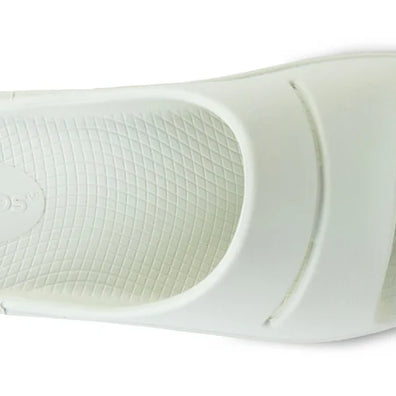 OOahh - Unisex by Oofos in white, lightweight slide with OOfoam strap for impact absorption and all-day support and comfort