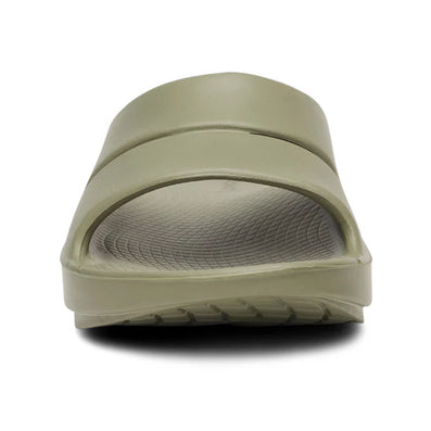 OOahh - Unisex by Oofos in olive green, lightweight slides with OOfoam strap for impact absorption and enhanced comfort