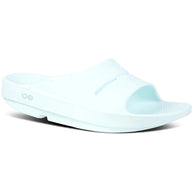 OOahh - Unisex by Oofos in light blue, slide sandals with OOfoam strap for impact absorption and comfort, ideal for recovery and casual wear