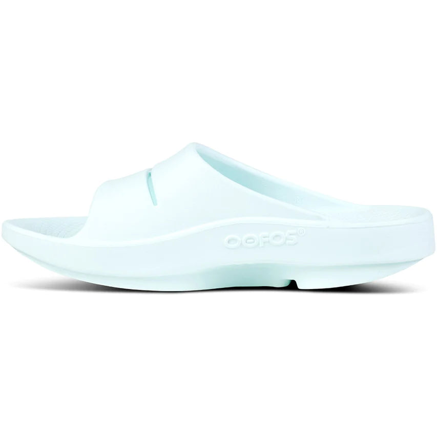 OOahh - Unisex by Oofos in light blue, comfortable slides with OOfoam strap for impact absorption and support, ideal for recovery and casual wear