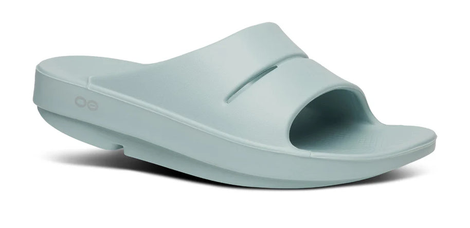 OOahh - Unisex slide by Oofos in light blue with OOfoam strap for impact absorption and comfort, ideal for recovery and casual wear