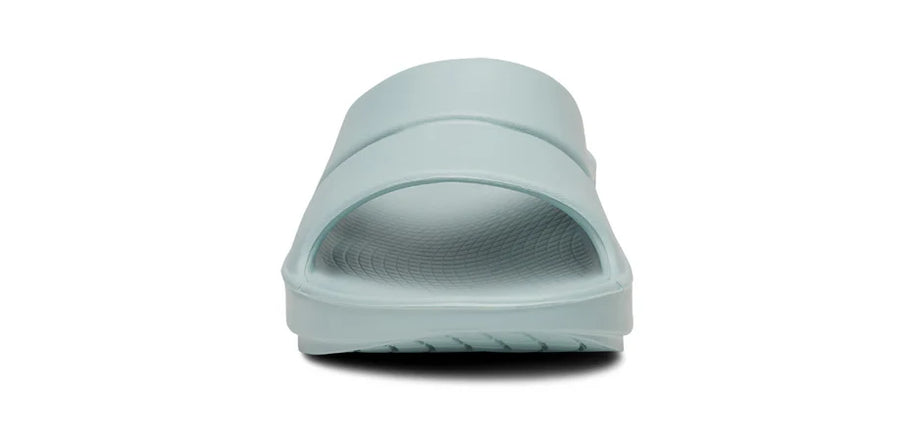 OOahh - Unisex by Oofos in light blue with OOfoam strap for impact absorption and support, ideal for recovery and casual wear