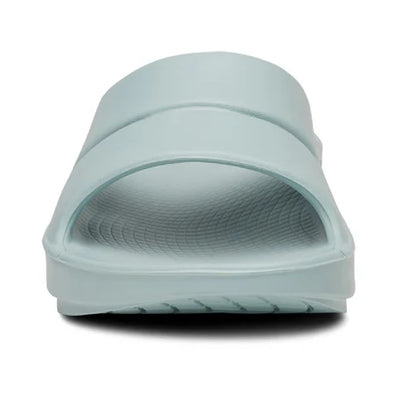 OOahh - Unisex by Oofos in light blue with OOfoam strap for impact absorption and support, ideal for recovery and casual wear