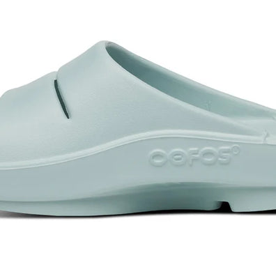 OOahh - Unisex by Oofos in pale blue with OOfoam strap for enhanced support, impact absorption, and comfort in slides designed for recovery and casual use