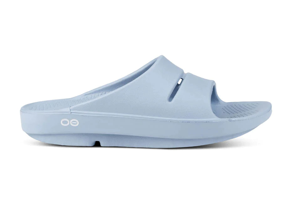 OOahh - Unisex by Oofos in light blue, slide with OOfoam strap for impact absorption and enhanced comfort, ideal for recovery and casual wear