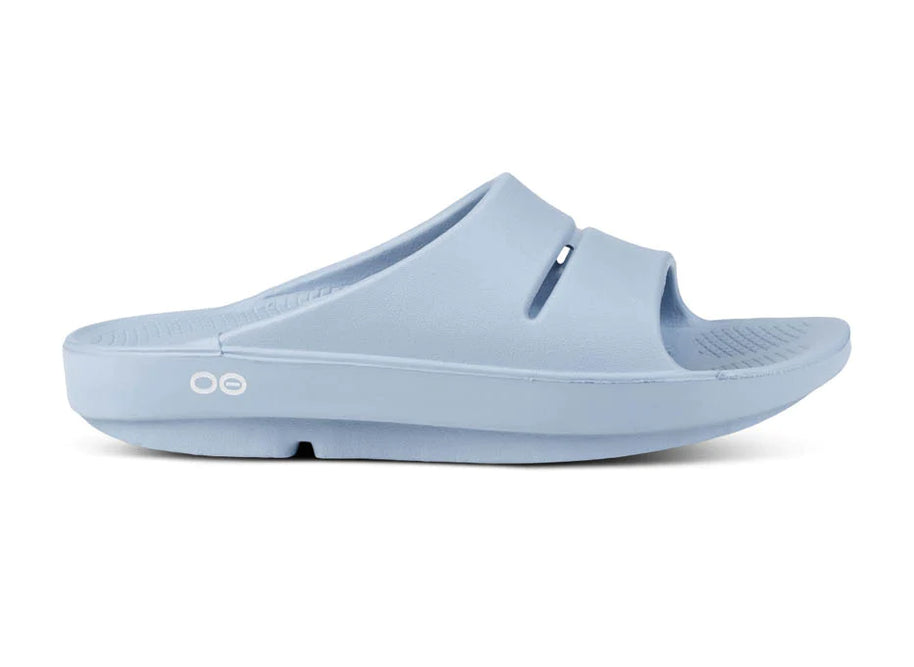 OOahh - Unisex by Oofos in light blue, slide with OOfoam strap for impact absorption and enhanced comfort, ideal for recovery and casual wear
