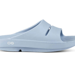 OOahh - Unisex by Oofos in light blue, slide with OOfoam strap for impact absorption and enhanced comfort, ideal for recovery and casual wear