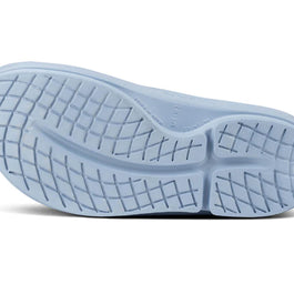 OOahh - Unisex by Oofos in light blue with OOfoam strap, impact-absorbing slides designed for comfort and recovery footwear use