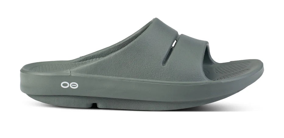 OOahh - Unisex by Oofos in dark green, lightweight slides with OOfoam strap for impact absorption and all-day comfort
