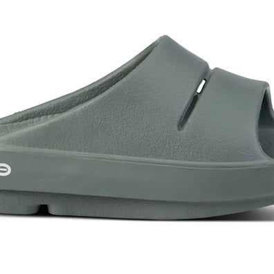 OOahh - Unisex by Oofos in dark green, lightweight slides with OOfoam strap for impact absorption and all-day comfort