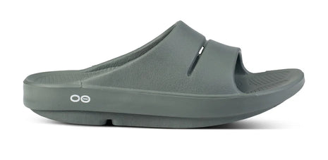 OOahh - Unisex by Oofos in dark green, lightweight slides with OOfoam strap for impact absorption and all-day comfort