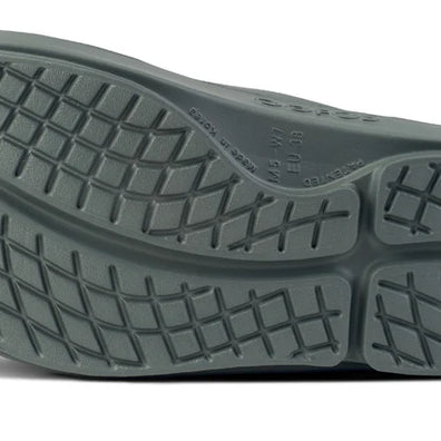 OOahh - Unisex by Oofos in dark grey with OOfoam strap, impact-absorbing slides designed for support and comfort in recovery and casual wear