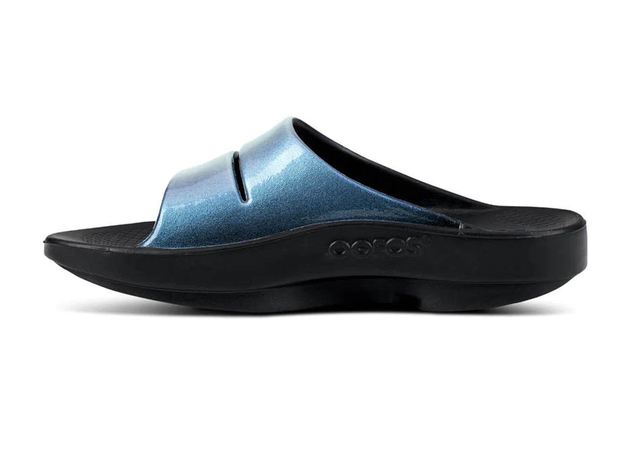 OOahh Luxe - Women by Oofos in metallic blue and black with agile OOfoam strap for support, comfort, and casual outdoor wear.