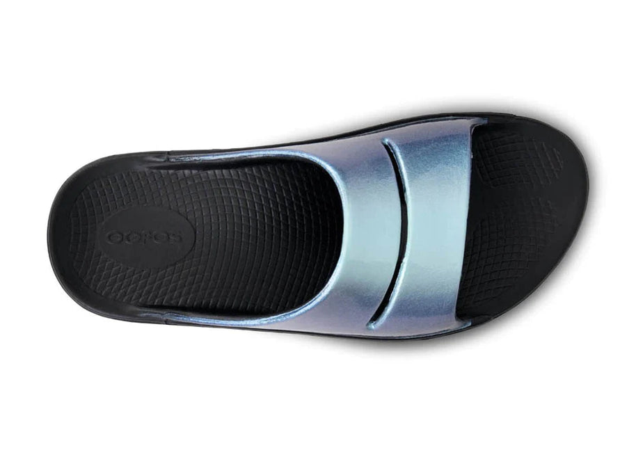 OOahh Luxe - Women by Oofos in metallic blue and black with agile OOfoam strap for support and comfort, ideal for recovery and casual wear