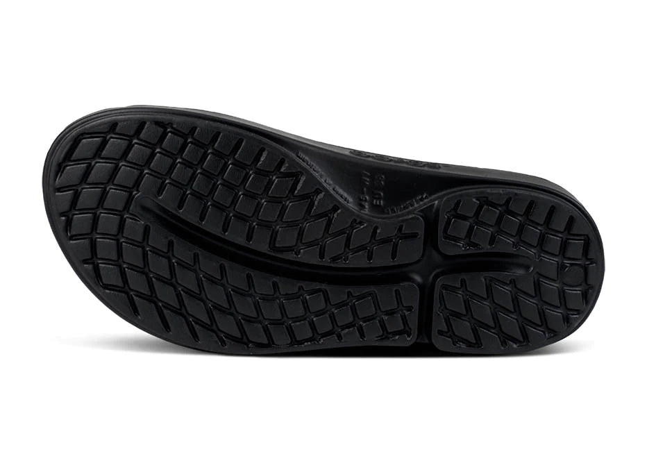 OOahh Luxe - Women by Oofos in black showing durable outsole with traction pattern, agile OOfoam strap for support and comfort slides