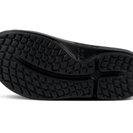 OOahh Luxe - Women by Oofos in black showing durable outsole with traction pattern, agile OOfoam strap for support and comfort slides