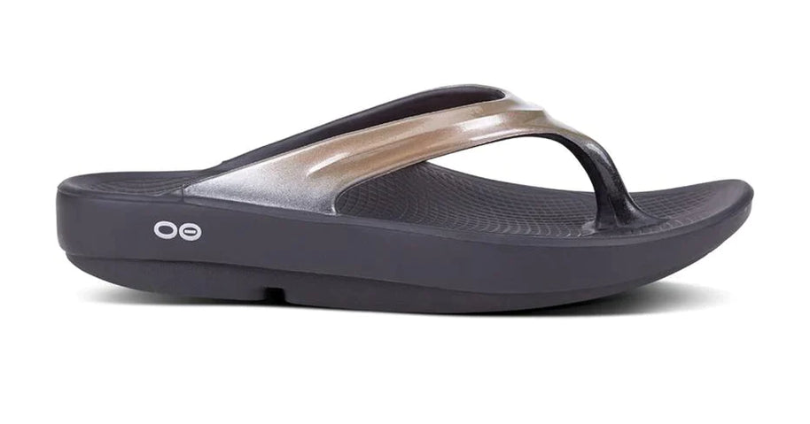 OOlala Luxe - Women by Oofos in black and metallic gold with patented OOfoam footbed, lightweight slides for all-day comfort and style