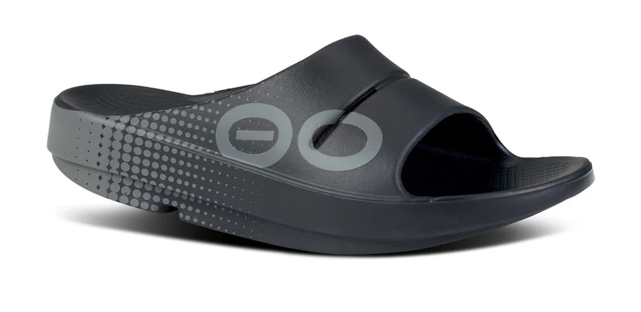 OOahh Sport - Unisex by Oofos in black with bold sporty graphics, agile OOfoam strap for support and 37% impact absorption