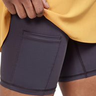 PRO Trail 2in1 Skirt - Women by Craft in yellow and black with 4-way stretch recycled polyester, ideal for high-performance trail running
