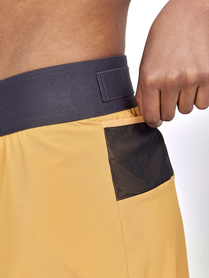 PRO Trail 2in1 Skirt - Women by Craft in mustard yellow with black pocket and navy waistband, 4-way stretch recycled fabric for trail running.