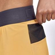 PRO Trail 2in1 Skirt - Women by Craft in mustard yellow with black pocket and navy waistband, 4-way stretch recycled fabric for trail running.