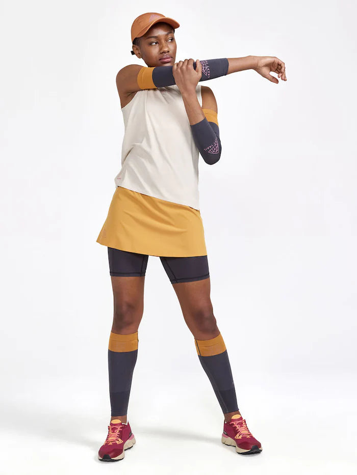 PRO Trail 2in1 Skirt - Women by Craft in mustard yellow with 4-way stretch recycled polyester for high-performance trail running.