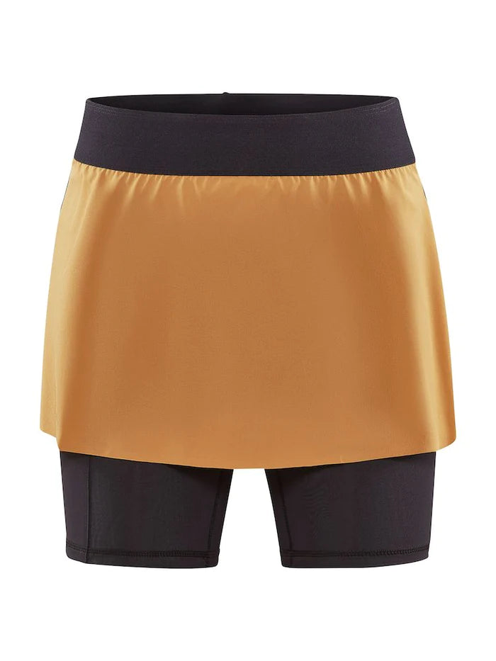 PRO Trail 2in1 Skirt - Women by Craft in mustard and black, 4-way stretch recycled polyester skirt with shorts for trail running.