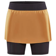 PRO Trail 2in1 Skirt - Women by Craft in mustard and black, 4-way stretch recycled polyester skirt with shorts for trail running.