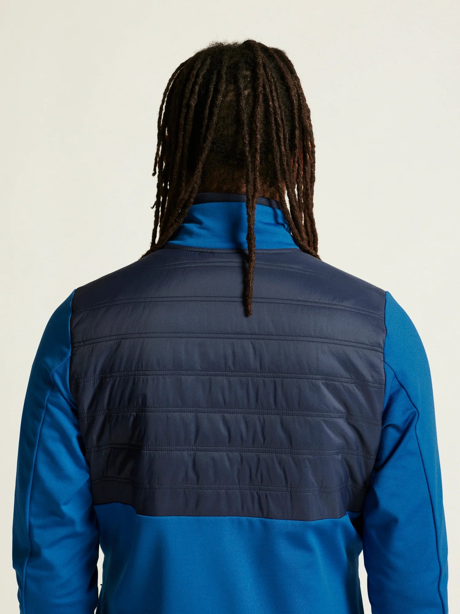 ADV Essence Warm Jacket 2 - Men by Craft in blue with black quilted padding, warm wind-protective jacket for cold weather workouts.