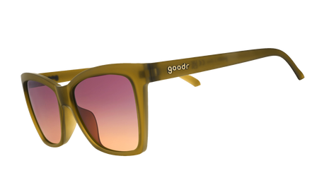 Goodr Sunbaked Sorcery sunglasses, side view of olive cat-eye frames with purple to peach gradient lenses