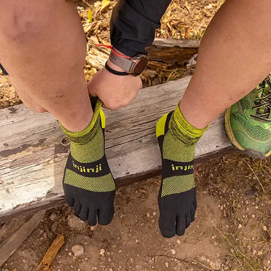 Trail Midweight Mini-Crew - Unisex by Injinji in black and lime green, cushioned toesocks for comfort and agility on uneven trails