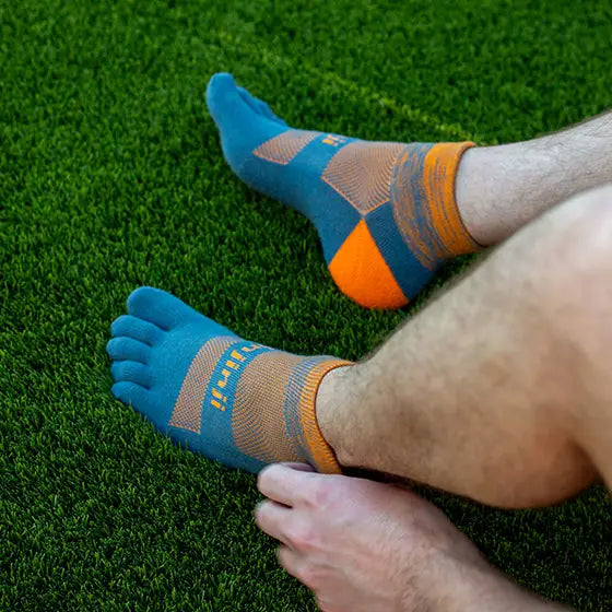 Trail Midweight Mini-Crew - Unisex by Injinji in blue and orange, cushioned toesocks for comfort, support, and agility on uneven trails.