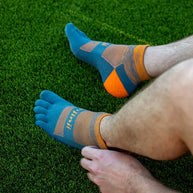 Trail Midweight Mini-Crew - Unisex by Injinji in blue and orange, cushioned toesocks for comfort, support, and agility on uneven trails.