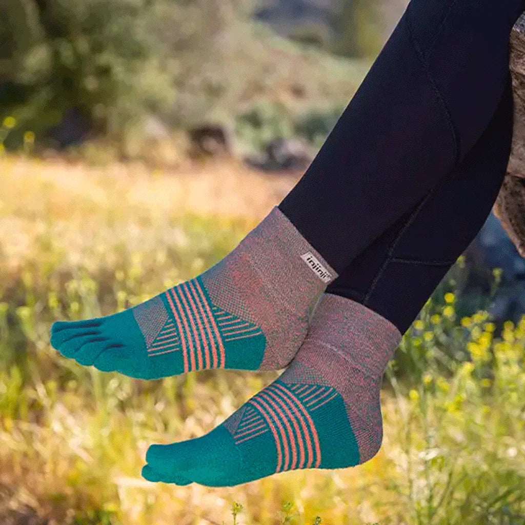 Trail Midweight Mini-Crew - Women by Injinji in teal and pink midweight toesocks engineered for comfort and support on uneven trails