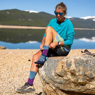 Trail Midweight Crew - Women by Injinji in blue and purple toe socks designed to reduce friction and provide comfort for rugged terrain running