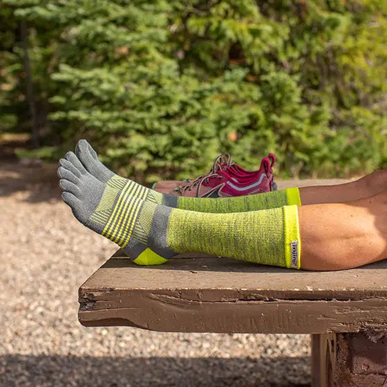 Trail Midweight Crew - Women by Injinji in grey and lime with individual toe fabric to reduce friction, ideal for fast movement on rugged terrain