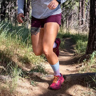Trail Midweight Crew - Women by Injinji in purple and grey, toe-sock design reducing friction, ideal for rugged trail running and fast movement outdoors