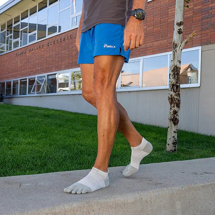 Injinji Run Lightweight No-Show - Unisex white five-toe socks designed for running with blister prevention and low bulk in a running store setting