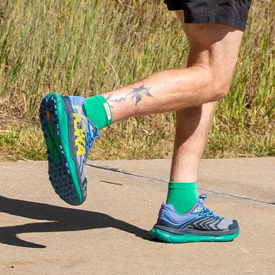 Run Lightweight Mini-Crew - Unisex by Injinji in bright green, designed to prevent blisters and provide comfort for running and outdoor activities