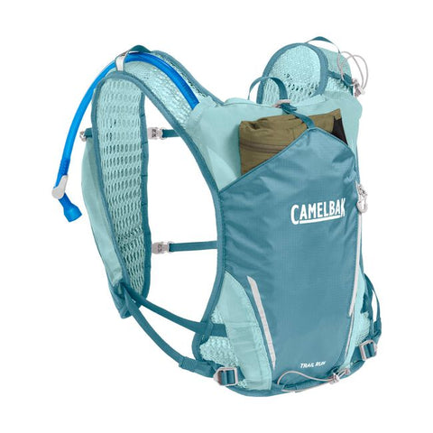 CamelBak Trail Run Vest 5.5L - Women in teal blue with hydration system, breathable mesh, ideal for trail running and mountain adventures.