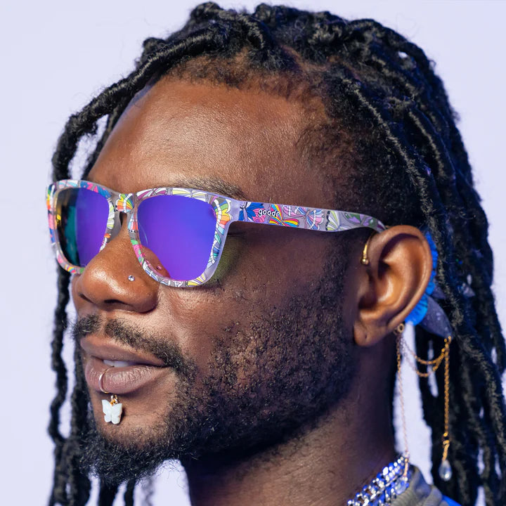 Is It Queer In Here Or Is It Just Us?! by Goodr clear frames with LGBTQ+ flag butterflies and purple lenses, unisex glasses for Pride celebration