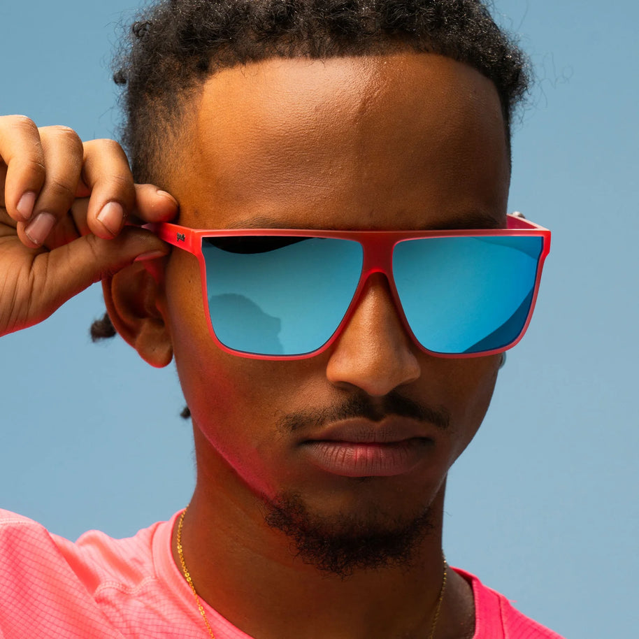 Entourage Sold Separately by Goodr in translucent hot pink with teal reflective lenses, stylish sunglasses ideal for bold outdoor use