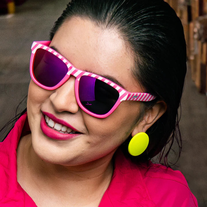 Road Twerk Ahead by Goodr in electric pink with hazard stripe design and rose reflective lenses, fun lightweight glasses for outdoor use