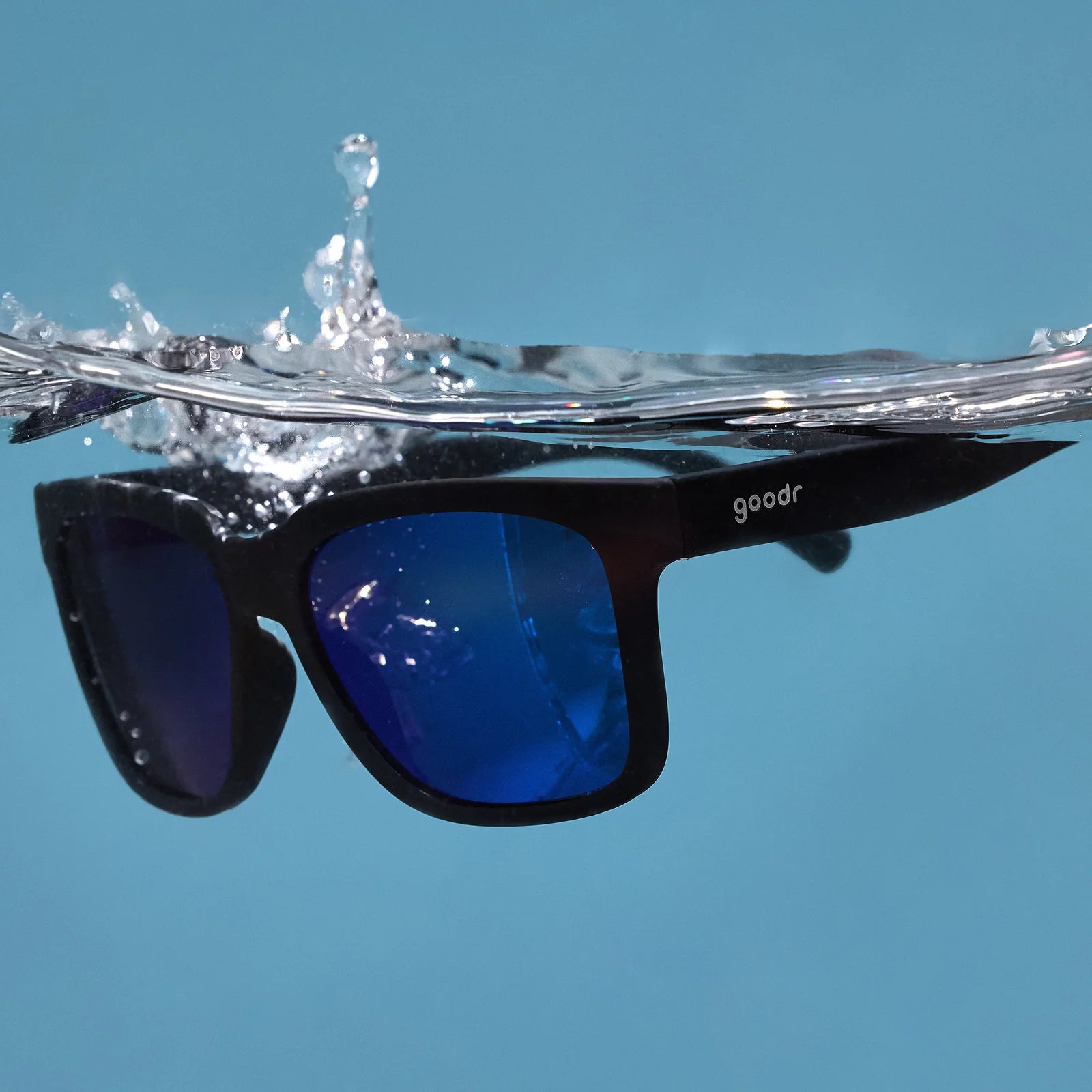 Buoys Don't Cry by Goodr in black with blue reflective water-repellent lenses, floating sunglasses for wave chasers and beach use